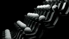 White balls rolling down black seats