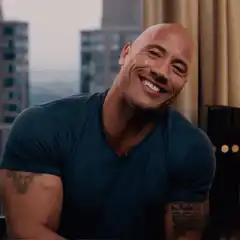 The Rock smiling then serious