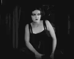 Woman in black dress dancing