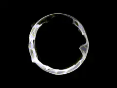 shimmering white ring on black background
