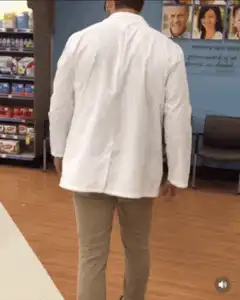 Pharmacist dancing in aisle