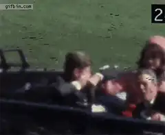 Jackie Kennedy crawls over JFK