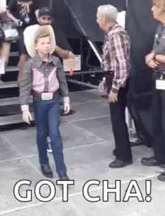 Kid cowboy does a magic trick