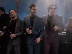 Three men dancing with beer bottles