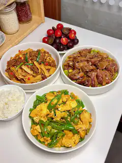 Chinese home-cooked meal with rice and fruit