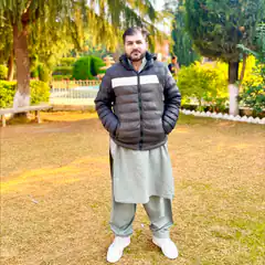 Man in park wearing puffer jacket