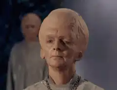 Bald alien character looking forward