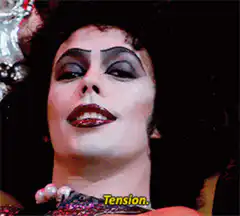 Cher smiles with caption Tension