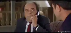 Danny DeVito on phone smirking