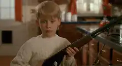 Macaulay Culkin with shotgun