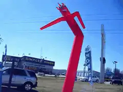 Red inflatable tube man waving