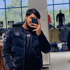Man taking mirror selfie in clothing store