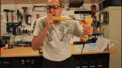 man biting banana with power drill