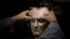 Man removes mask to reveal robot face