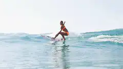 Woman surfing and wiping out