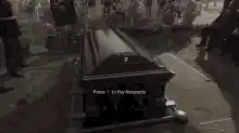 Hand touches coffin lid
