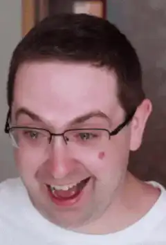 Man laughing then shocked face