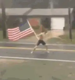 man running with american flag