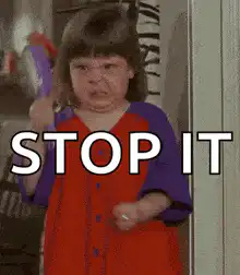 Angry toddler girl with brush saying stop it