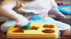 Baby plays with shape sorter toy