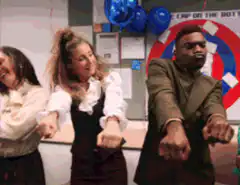 The Office staff celebrating with We Did It banner