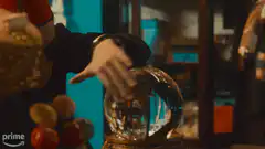 Man in fez and sunglasses doing magic over crystal ball