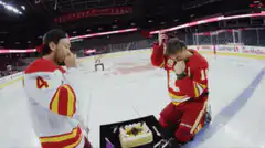 Calgary Flames players celebrate with cake on ice