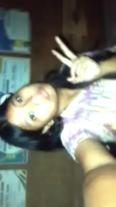 girl making peace sign selfie