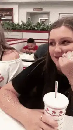 Boy playing with phone at In-N-Out