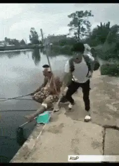 Man pulls fishing rod and falls into water