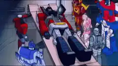 Megatron lying on a table surrounded by Decepticons