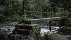 old wooden bridge over stream