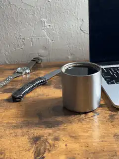 coffee cup and knife on desk