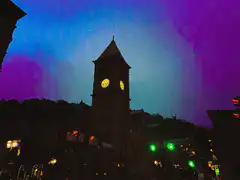 clock tower with shifting aurora sky