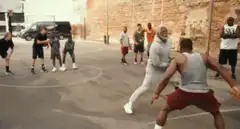 Man in grey hoodie makes a basketball shot
