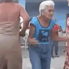 Old man dancing in blue shirt