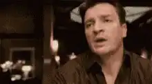 Nathan Fillion pointing and facepalming