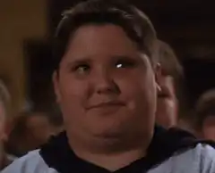 Fat kid smirking and looking around