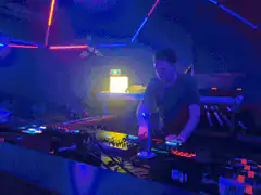 DJ performing with laser lights