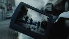 TV screen showing street scene with smoke