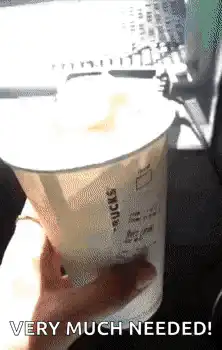 Dog licks whipped cream from Starbucks cup