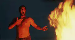 Tom Hanks shirtless by fire