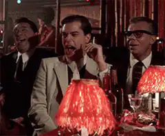 Tom Cruise laughing hysterically at a table