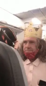 Man in crown screaming on plane