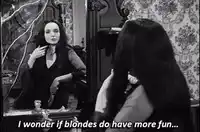 Morticia Addams looking in mirror