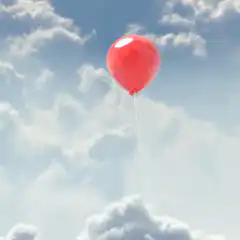 red balloon floating in sky