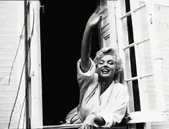 Marilyn Monroe waving from window