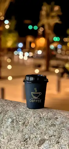 Coffee cup on stone at night