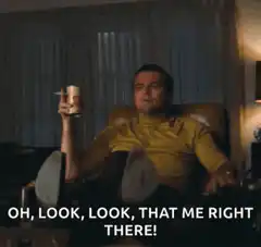 Leonardo DiCaprio pointing with drink