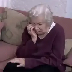 Old lady crying on couch